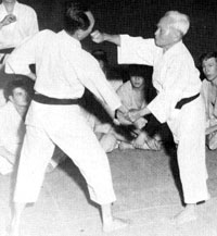 Funakoshi demonstrating a single knuckle strike to a vital point